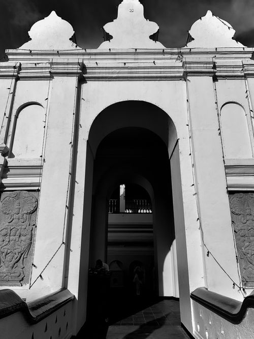 Free Explore the ornate architectural entrance of Kandy's iconic landmark in black and white. Stock Photo