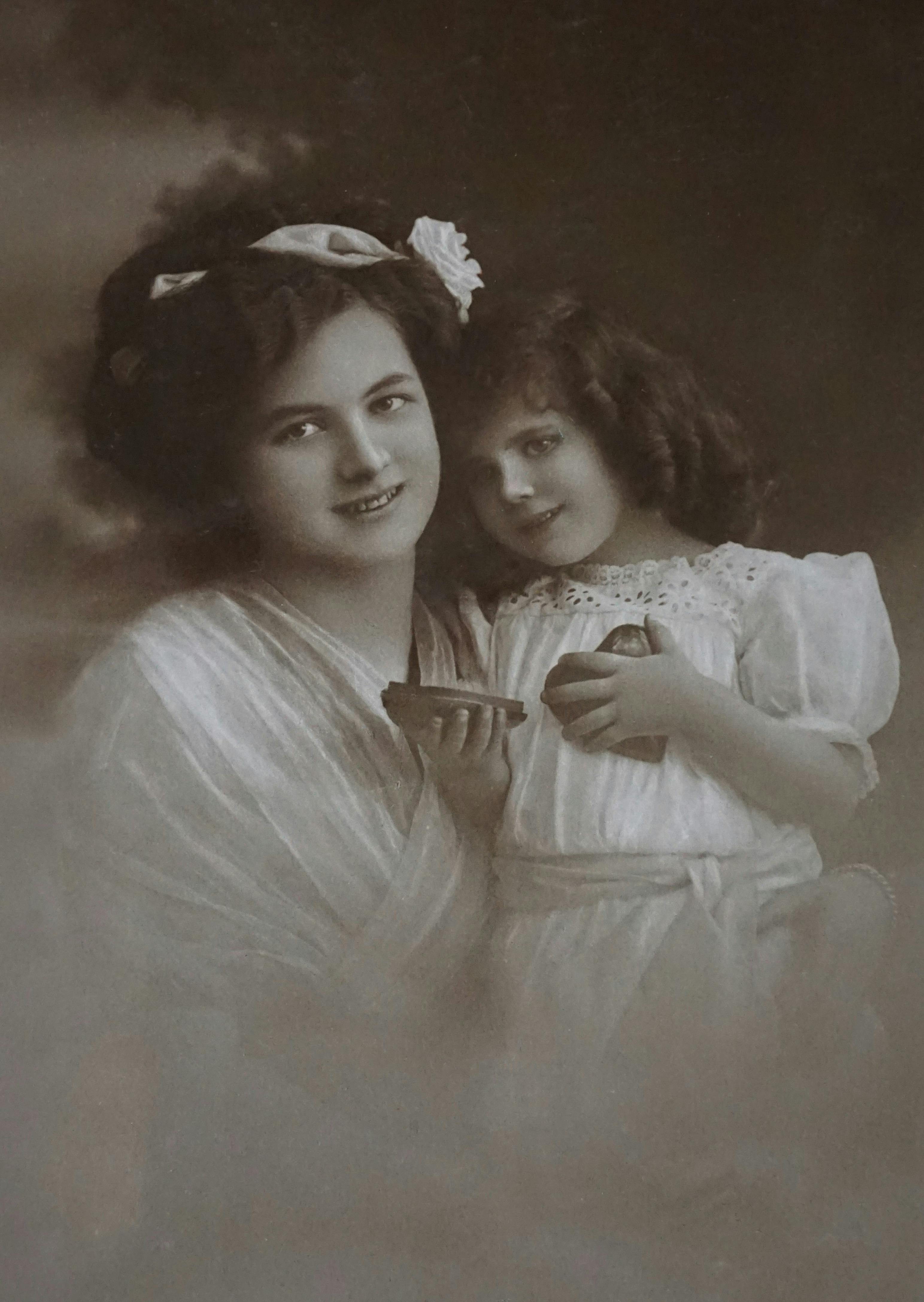 Sepia portrait capturing a mother and daughter in vintage attire.