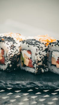 Delicious sushi rolls topped with caviar, beautifully presented for a gourmet dining experience.