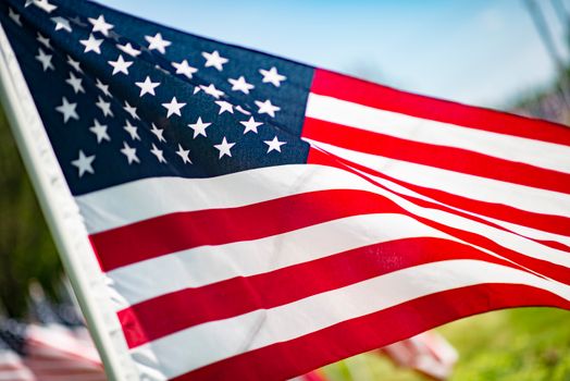 Close-up of the American flag waving in the summer breeze, symbolizing freedom and patriotism.