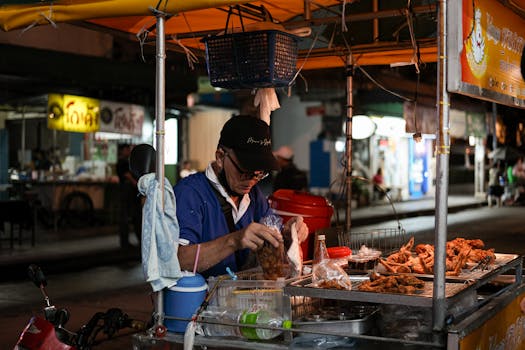 Nighttime street food vendor in Bangkok, capturing the vibrant city life and local cuisine.