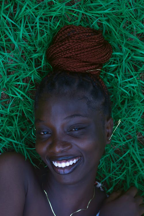 Smiling Woman Lying Down on Ground