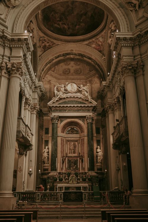 Free Explore the ornate architecture and grand altar of this historic Italian church. Stock Photo