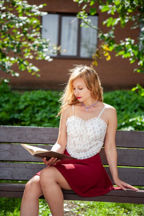 A Woman Reading a Book Outdoors