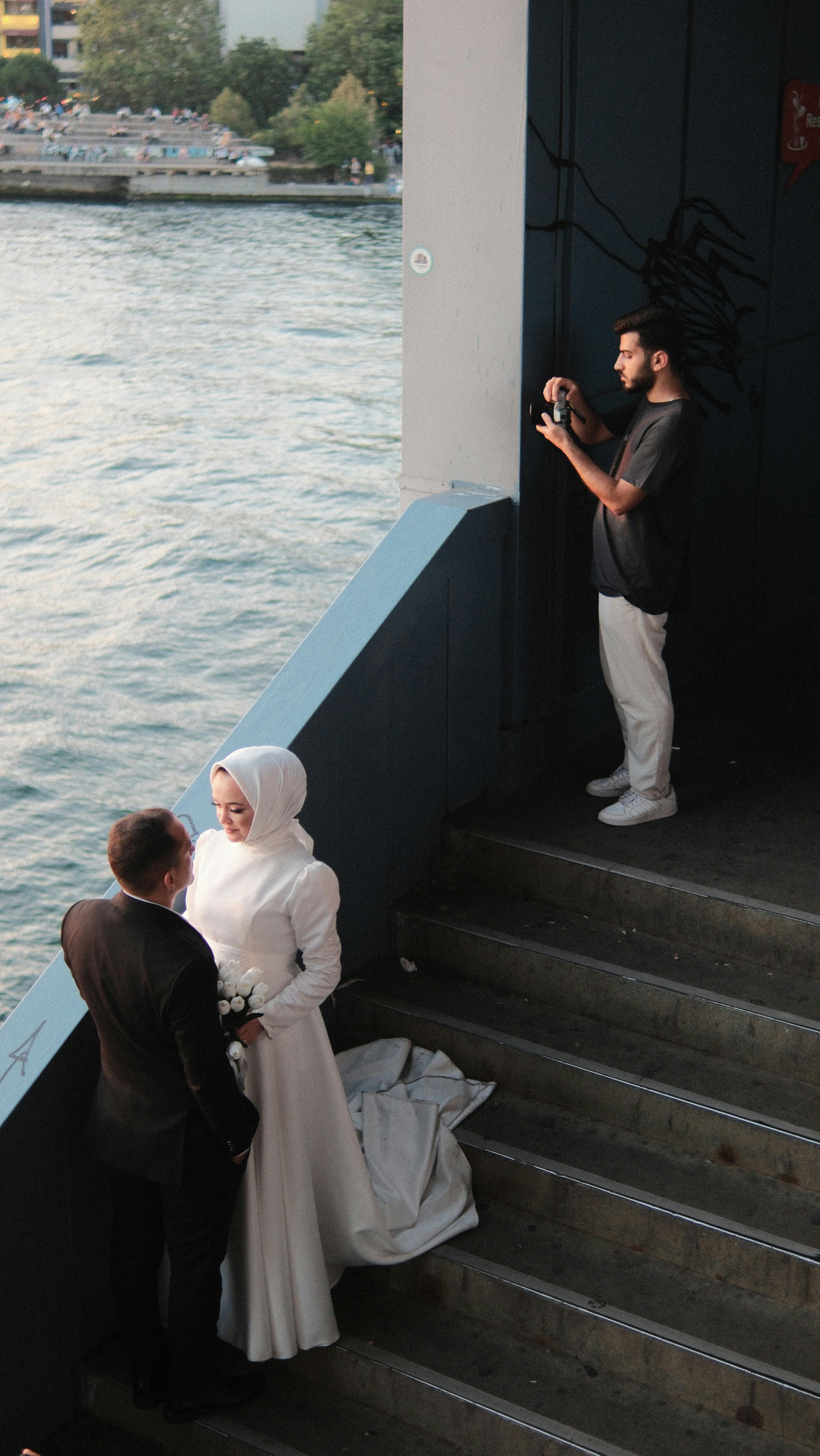 Captivating wedding photoshoot featuring a couple by the riverside, captured by a professional photographer.