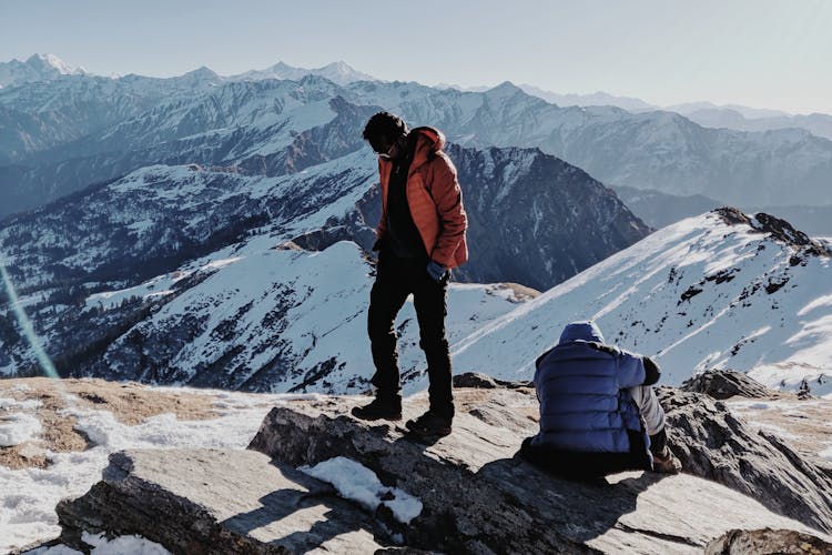 Two People On Top Of A Mountain