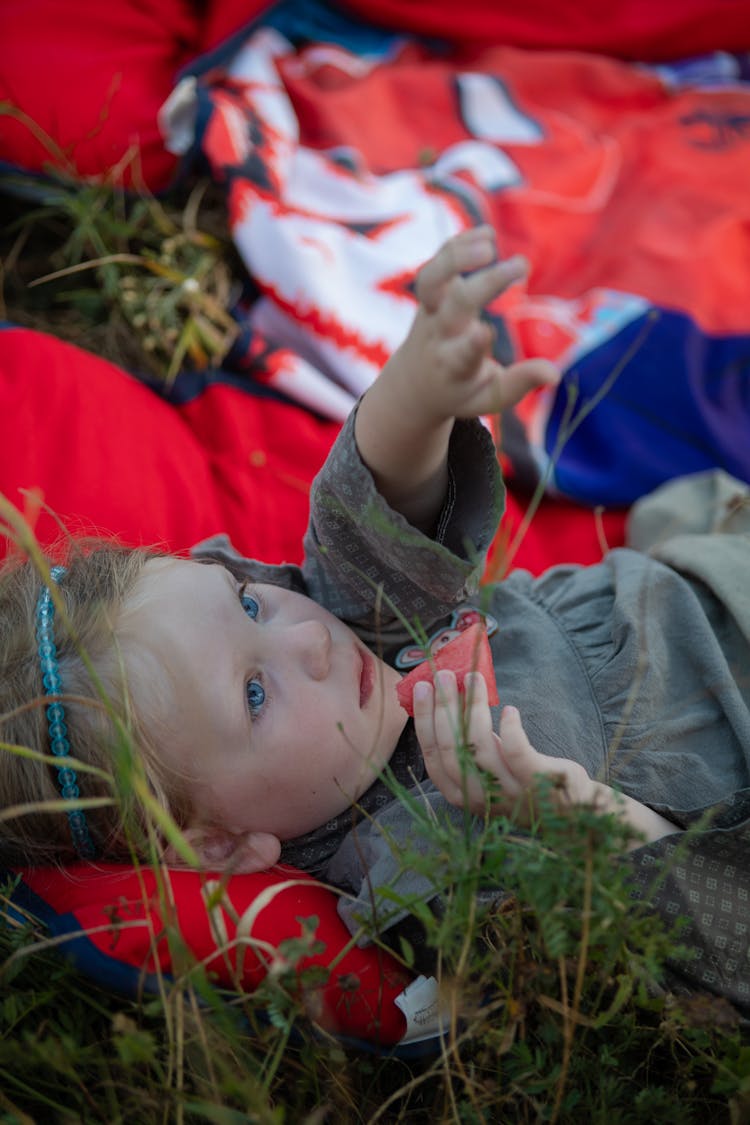 Girl Eating Watermelon Lying On Blanket