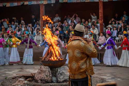 Free A vibrant cultural festival featuring traditional dances around a bonfire with a musician performing. Stock Photo