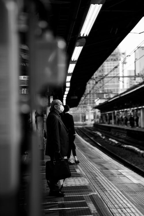 Man Waiting on a Platform for the Train