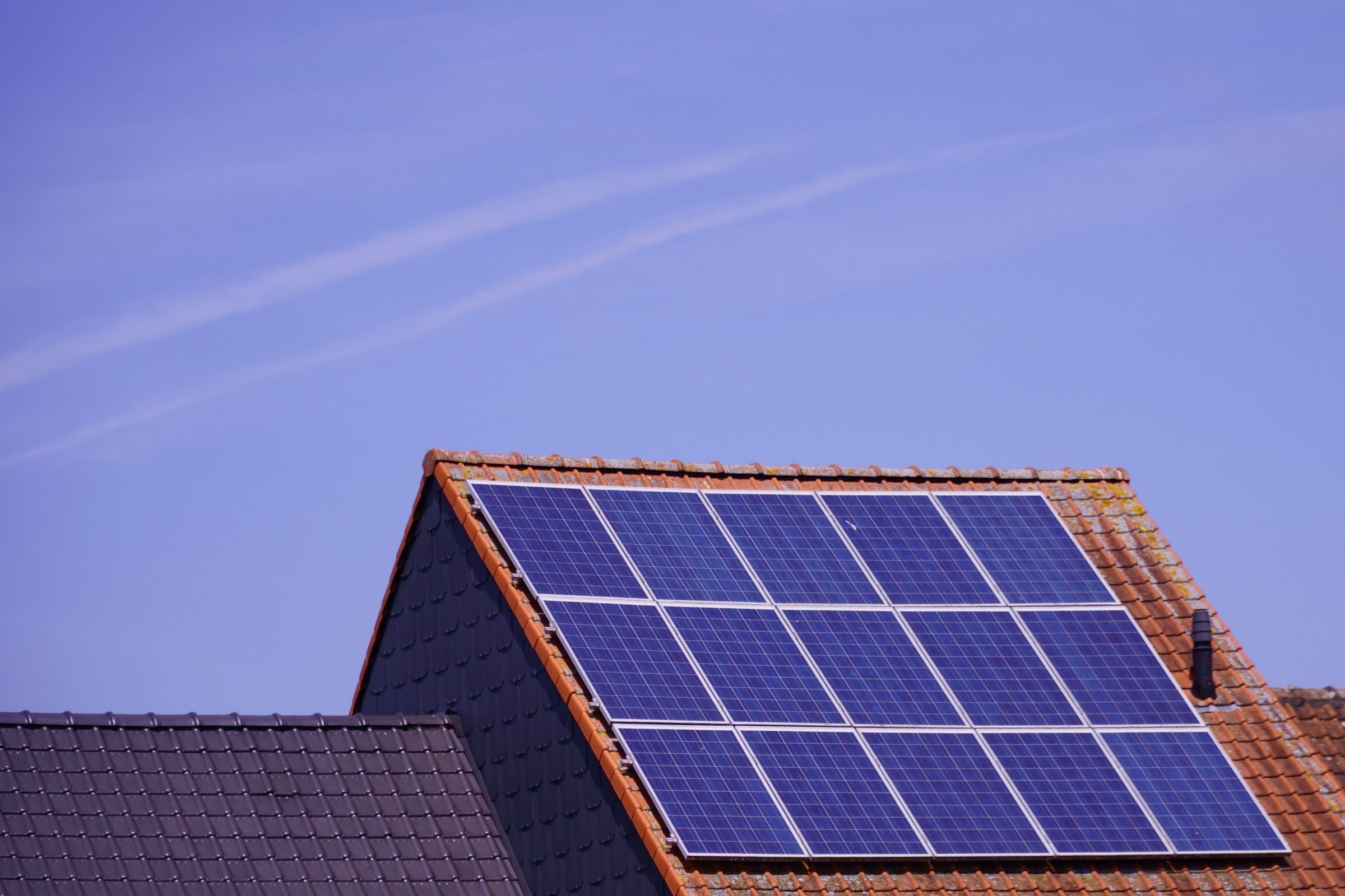Close-up of solar panels on a rooftop under clear sky