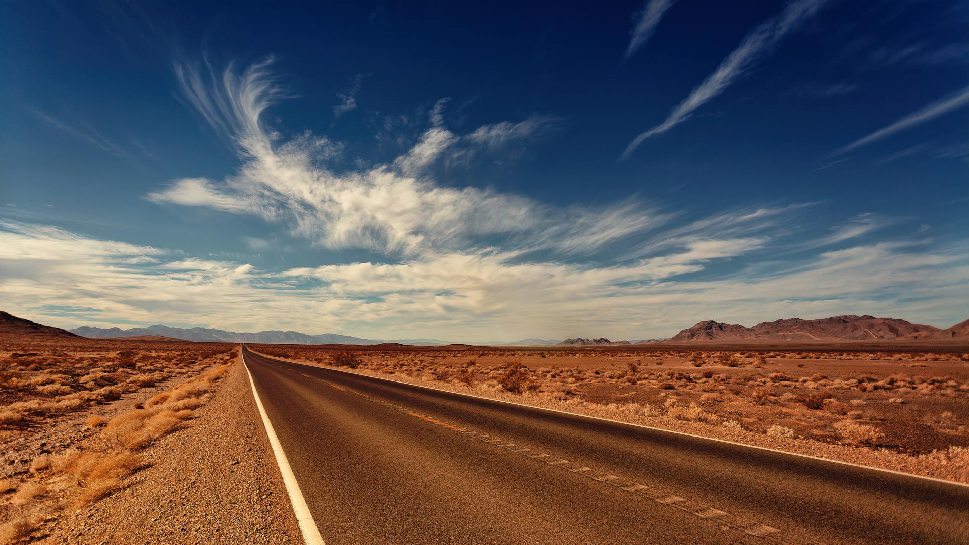 Asphalt Road Under White Clouds