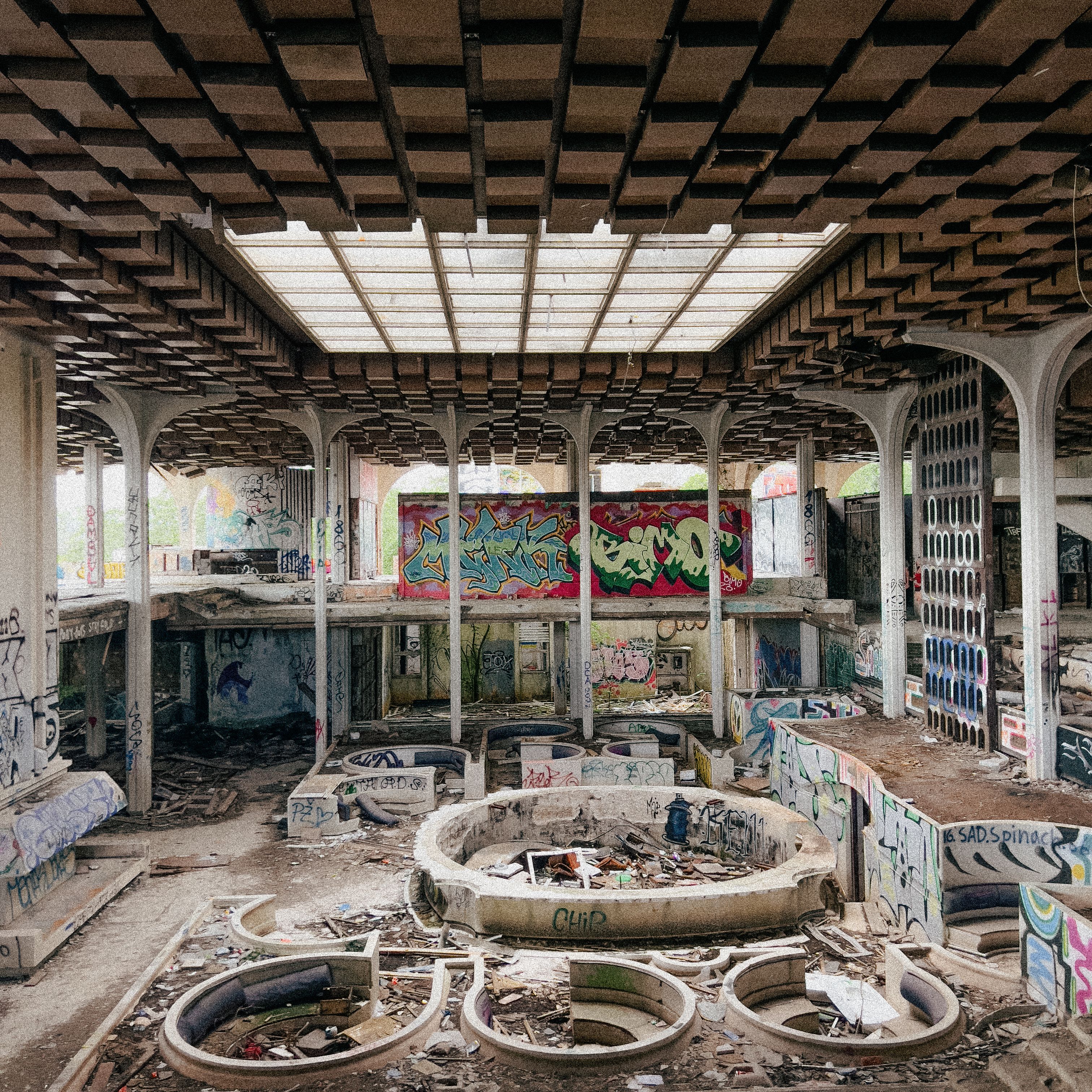 Interior of a graffiti-covered abandoned building in Krk, Croatia, showcasing urban decay and destruction.