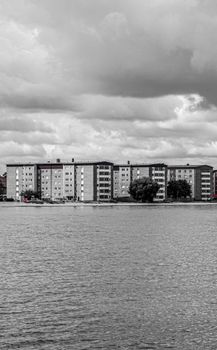 Monochrome view of residential buildings along the waterfront in Jönköping, Sweden.