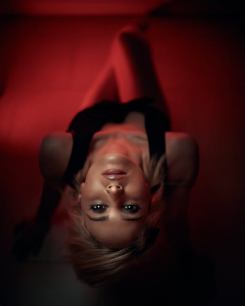 Studio Shot of a Young Woman Sitting and Looking Up 