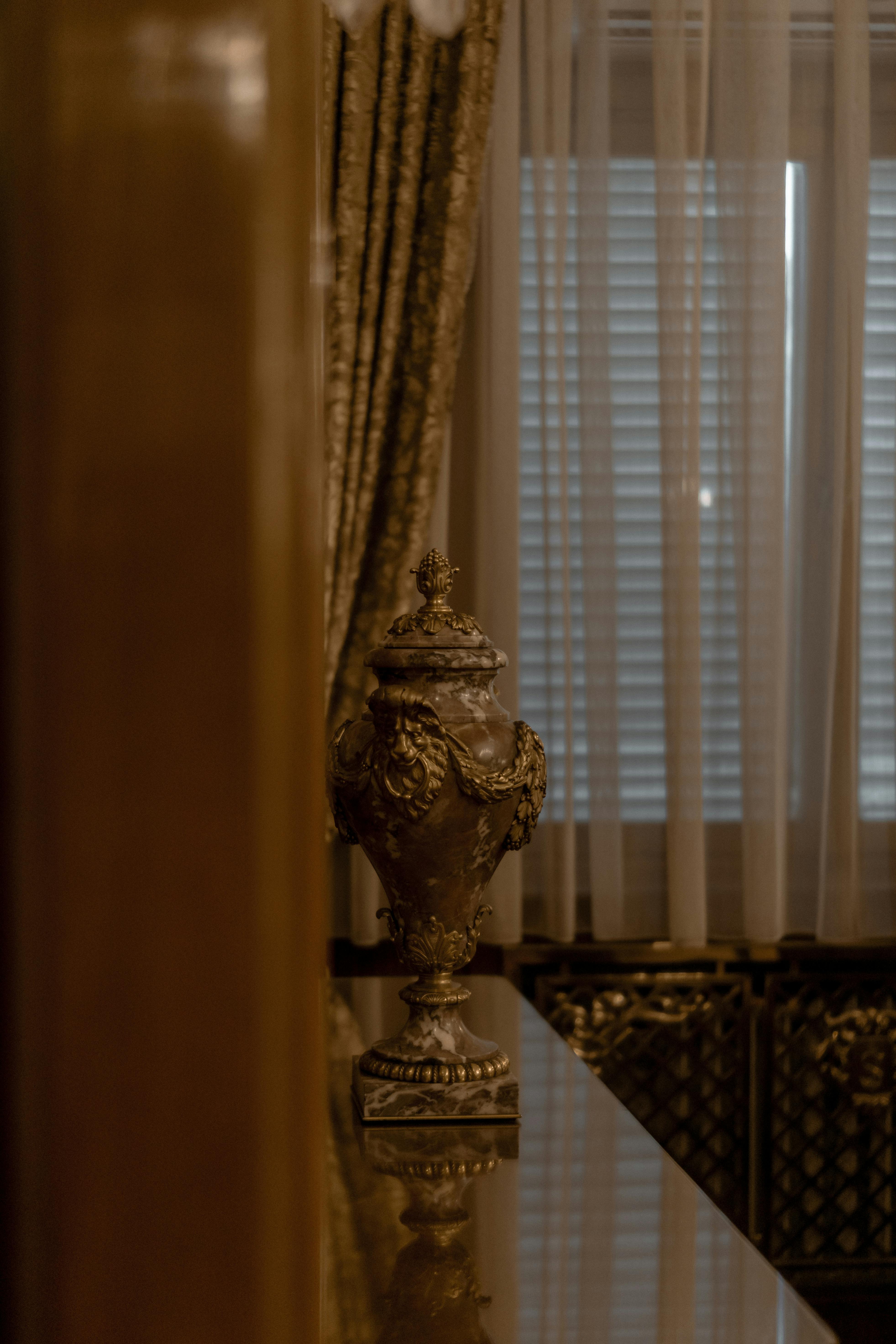 ornate urn standing on a shiny shelf