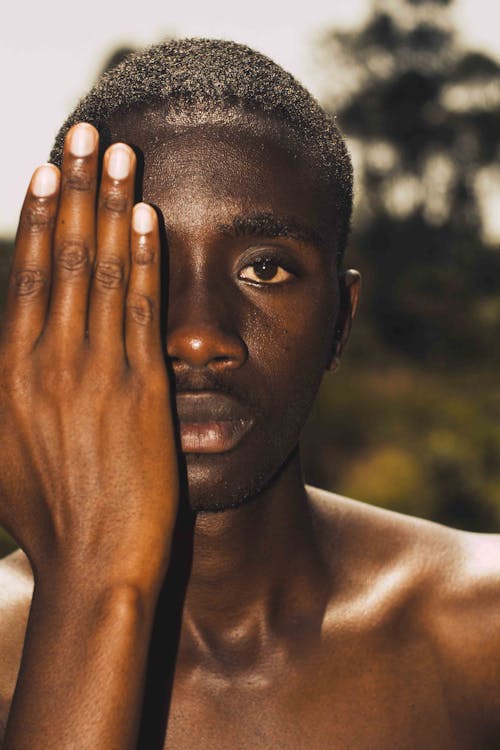 Man Covering Face with Hand