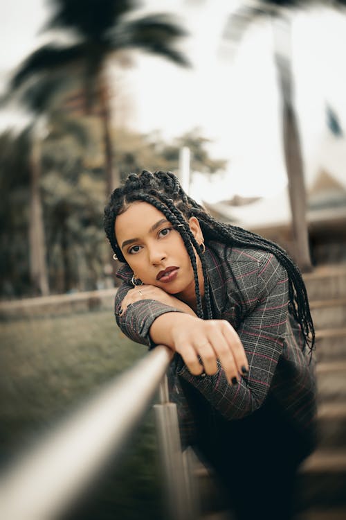 Woman Posing on a Wooden Bridge Among Palms 