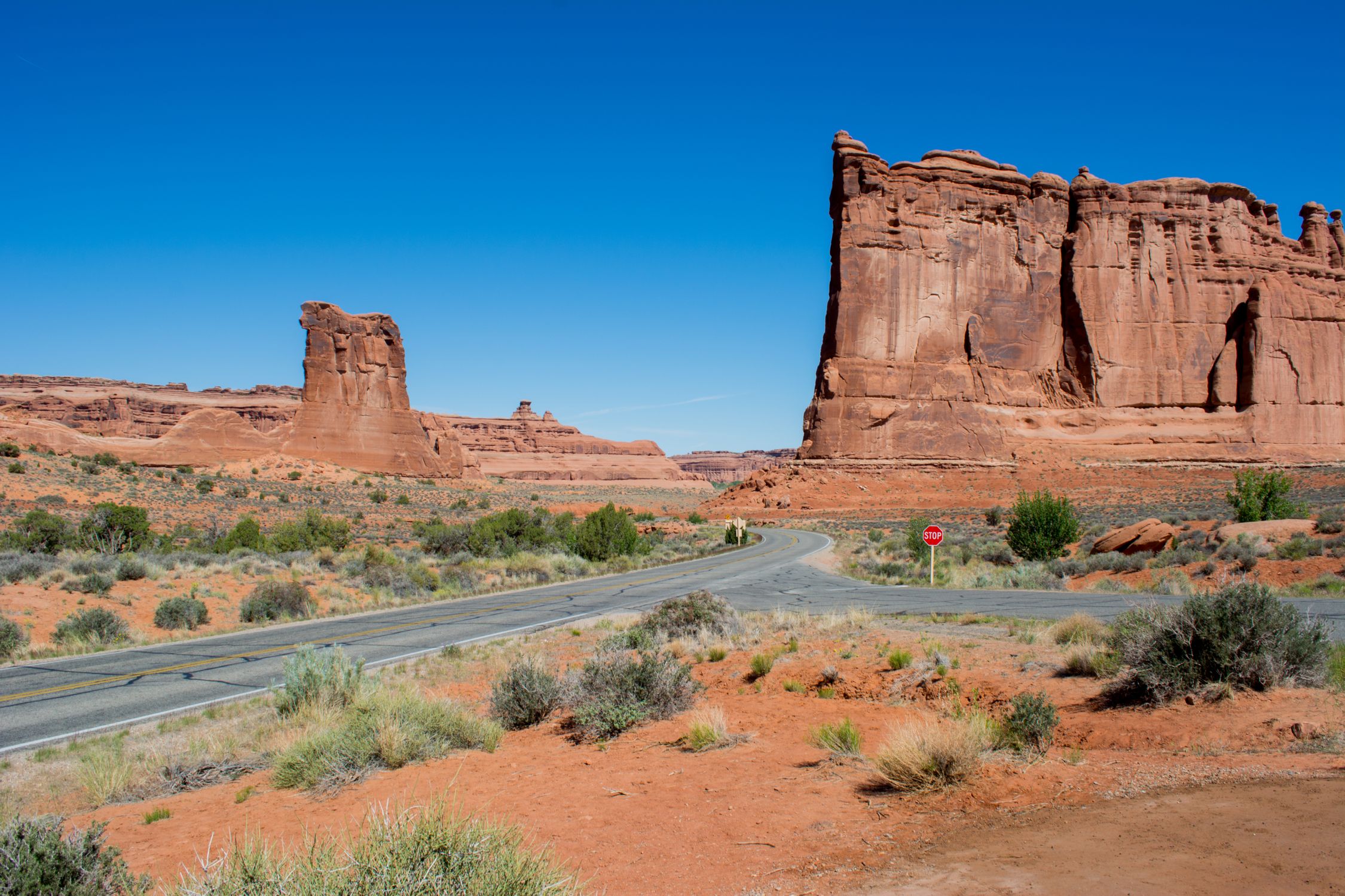Stunning view of red rock formations under a clear blue sky in Arches National Park, Utah