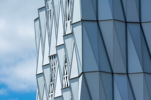 Free Close-up of a modern geometric building facade in Nantes, France, under a clear sky. Stock Photo