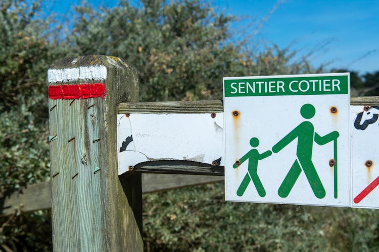 Close-up Of A Sign On A Wooden Fence