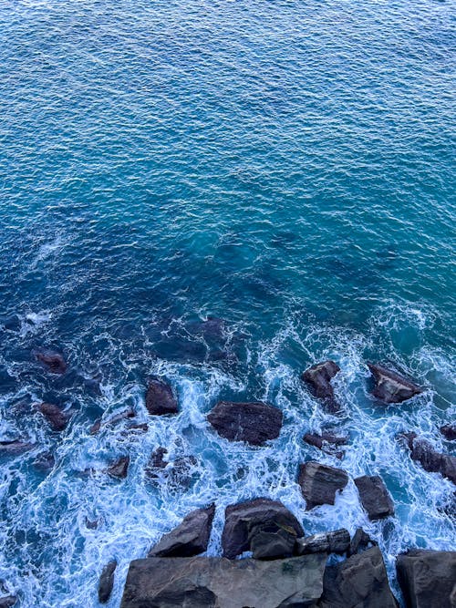 View of Foamy Waves Breaking on a Rocky Shore 