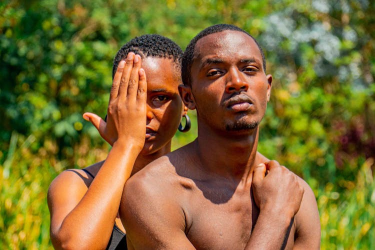 Man And Woman Covering Face With Hand