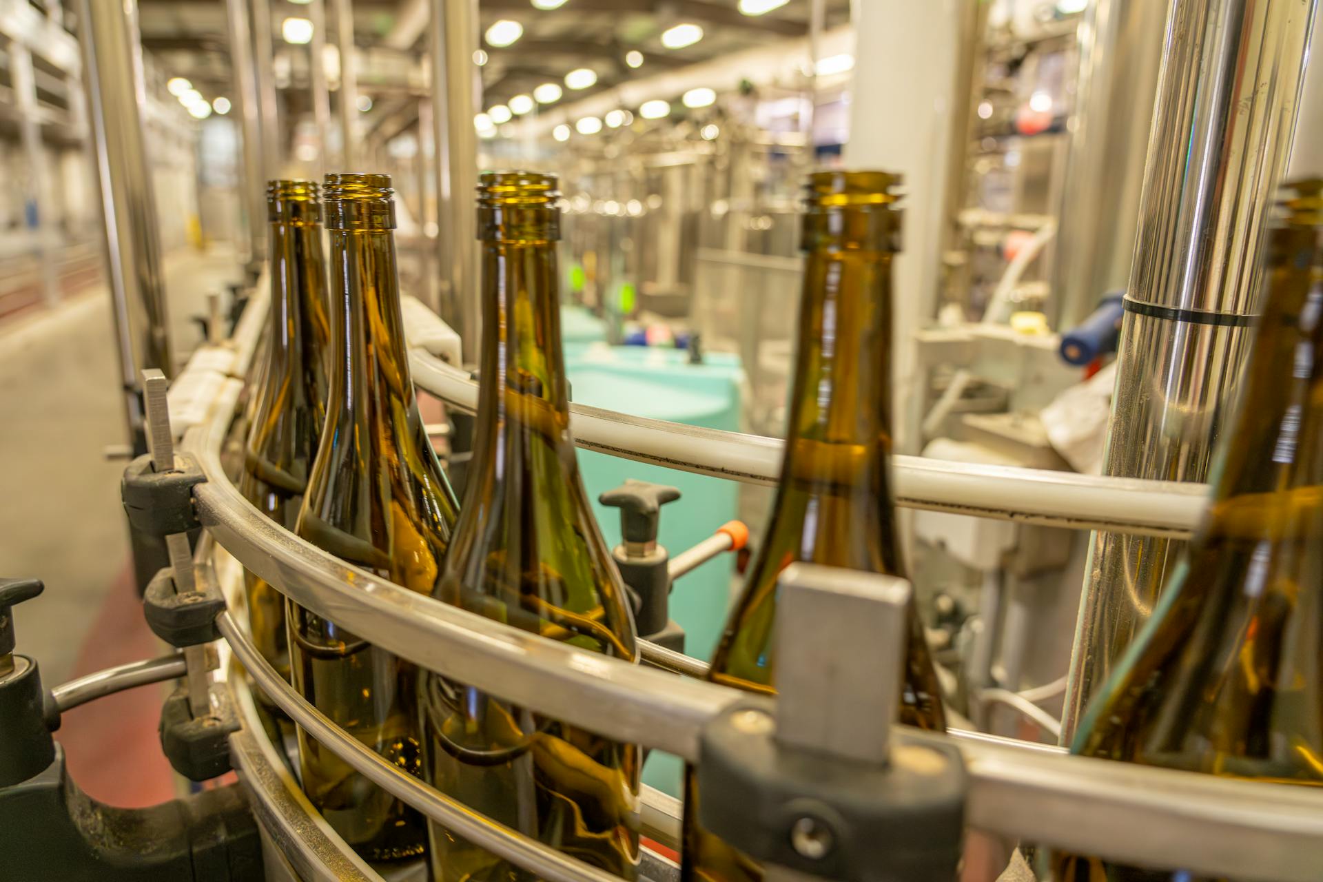 Close-up view of glass bottles on an industrial production line in a manufacturing facility.
