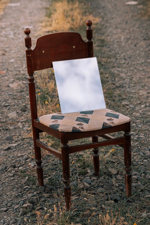 Blank Paper Sheet on Chair on Dirt Road
