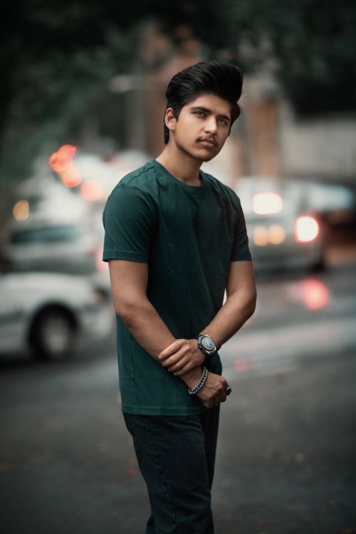 Free Portrait of a fashionable young man standing confidently on a city street in Tehran, Iran. Stock Photo