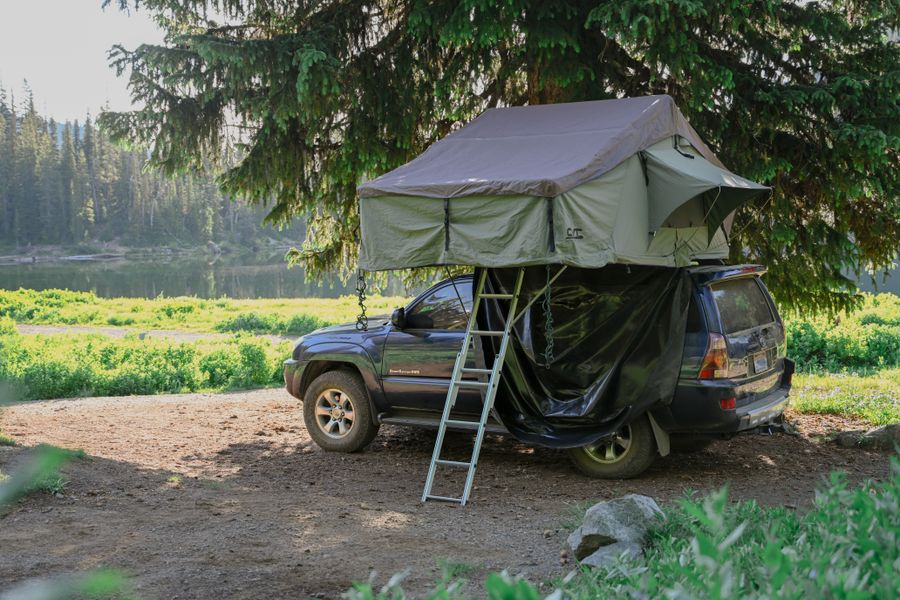 Illustrative rooftop tent at a campsite