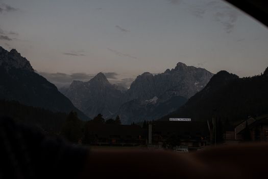 Peaceful dusk view of mountains and rural landscape with cloudy skies.
