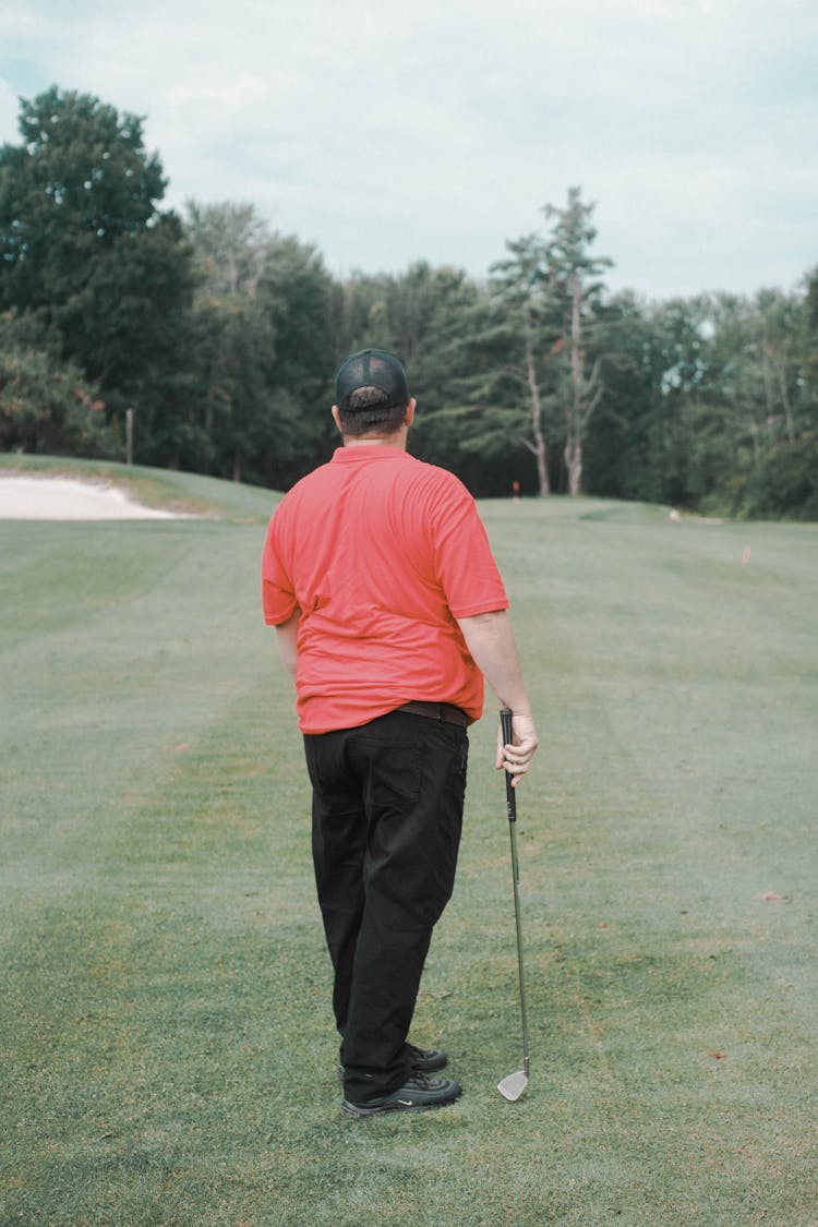 Male Golfer Standing On A Golf Course