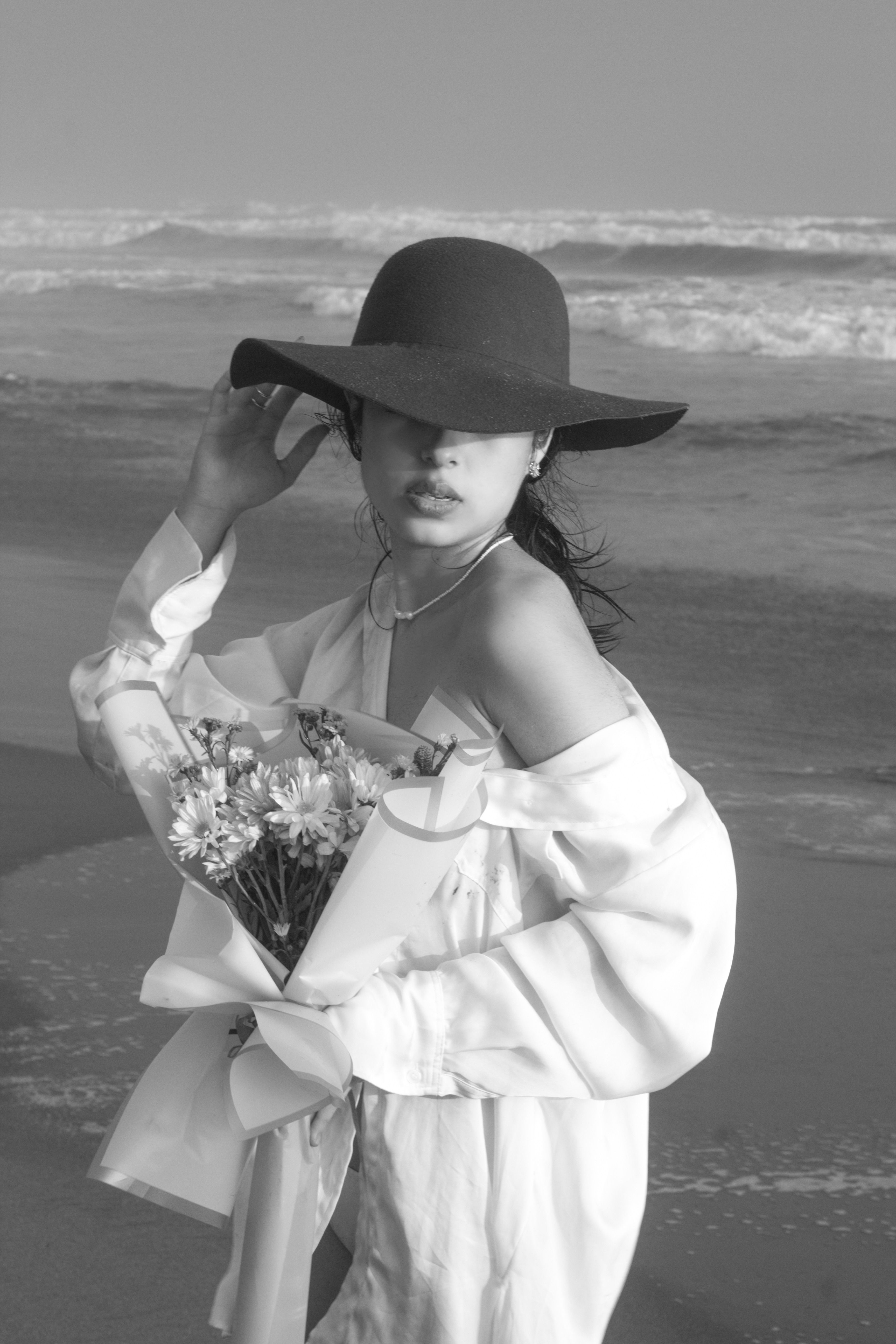 Woman with a Bouquet of Flowers in Black and White · Free Stock Photo