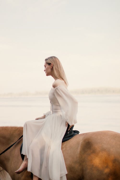 Woman Sitting on Horse in Strapless Sundress