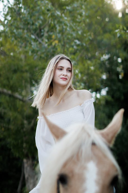 Blonde Woman Long Sleeved Dress on Horse