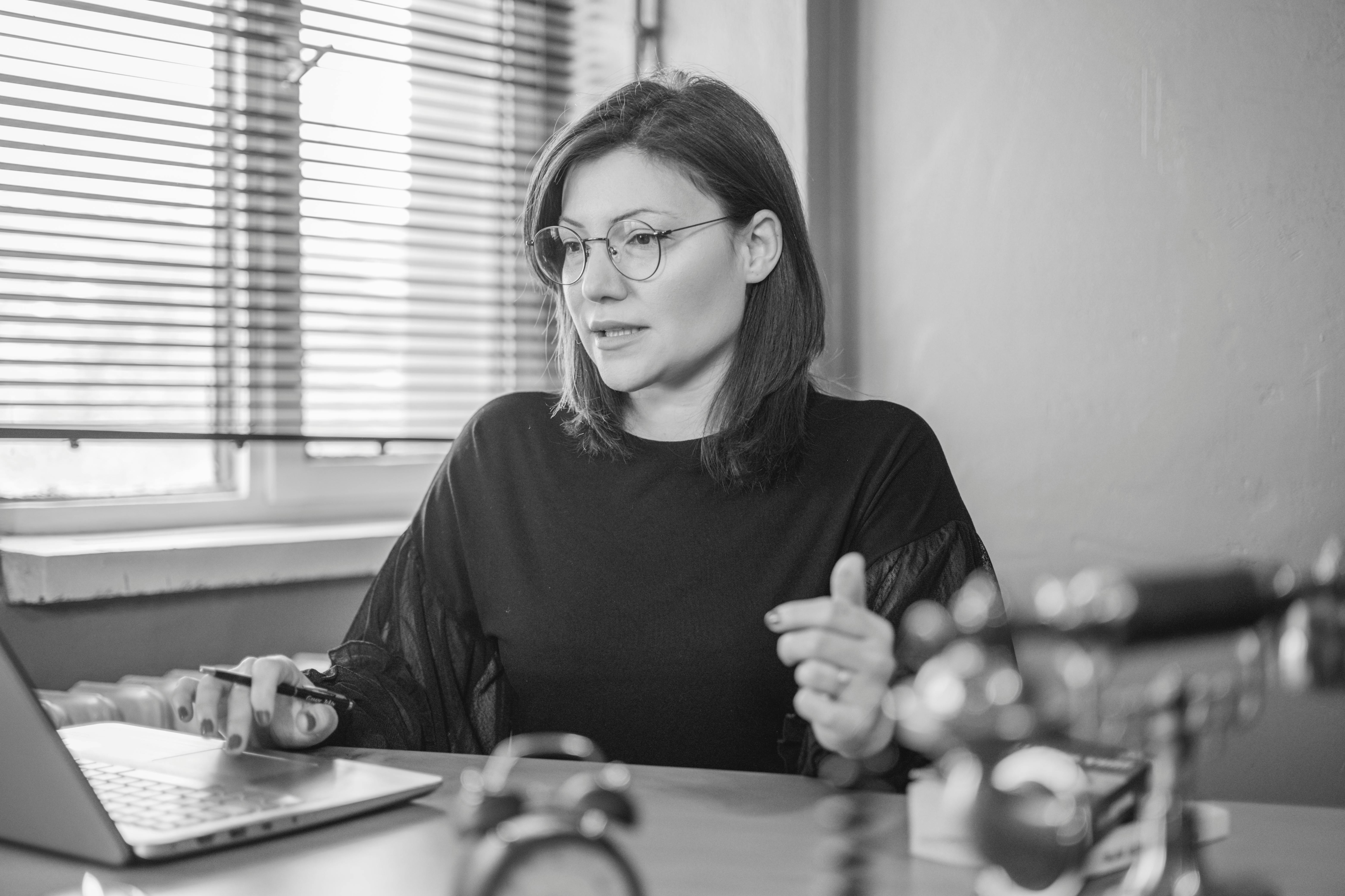 Woman Sitting at Desk with Laptop