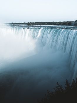 Experience the stunning power of Niagara Falls in a captivating vertical viewpoint.