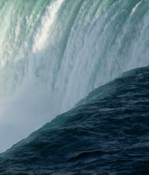 Captivating close-up shot of Niagara Falls showcasing the powerful cascade and misty spray.