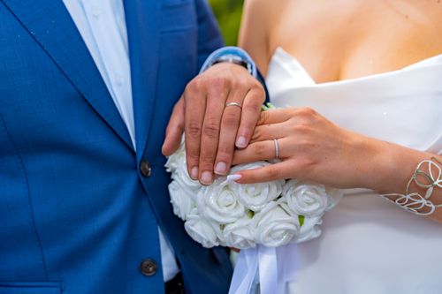 Free Close-up of bride and groom's hands with wedding rings, symbolizing love and commitment. Stock Photo