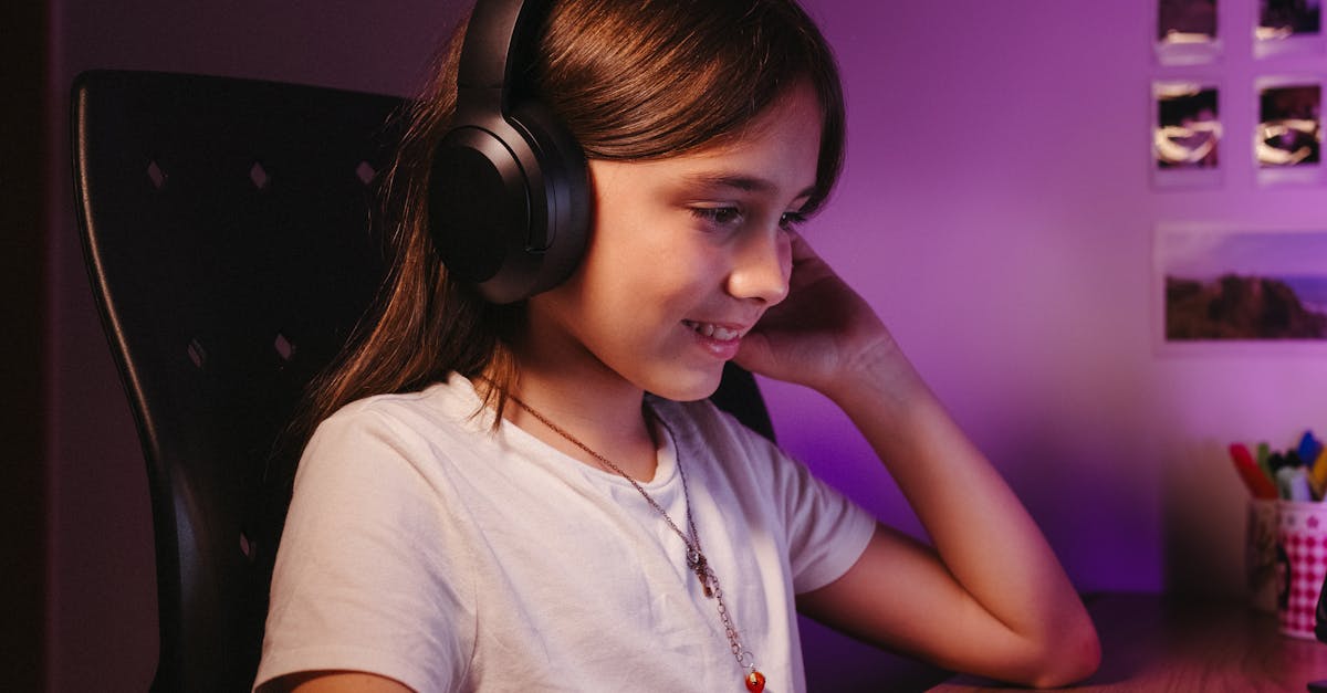 A laptop showing an online educational video lecture with colorful graphics and subtitles.