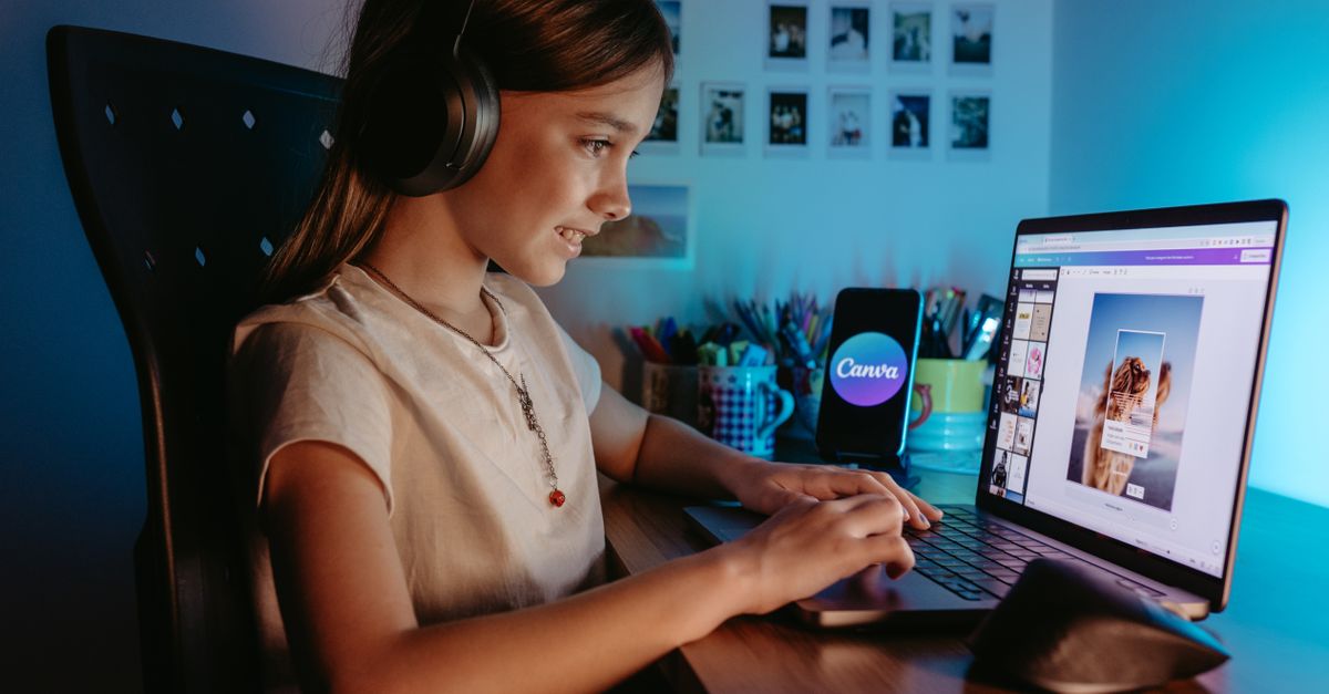 Girl using a laptop with headphones in a cozy indoor workspace for graphic design.