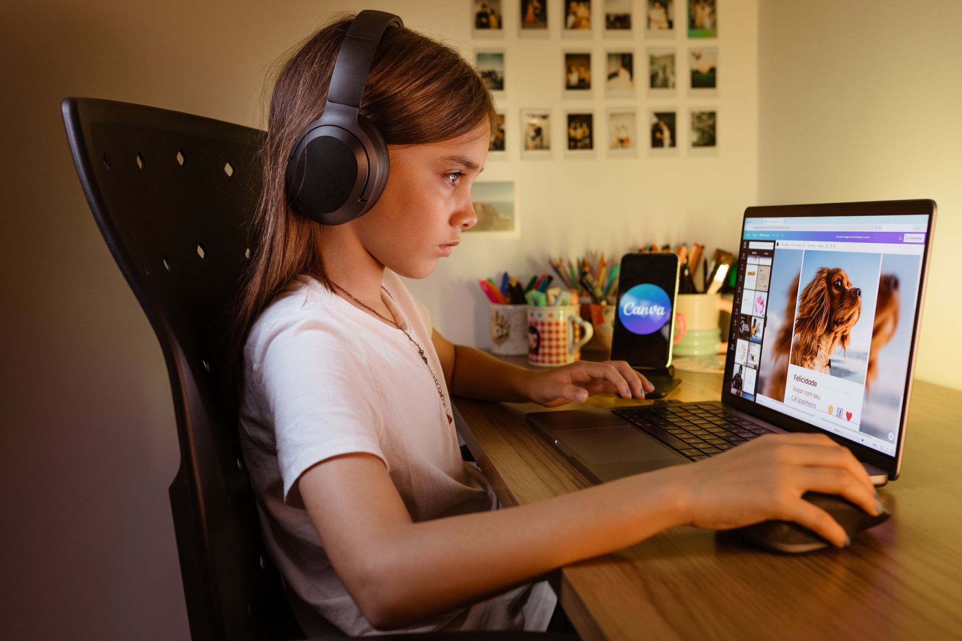 A young girl wearing headphones is focused on her laptop, engaging with educational content at her desk.