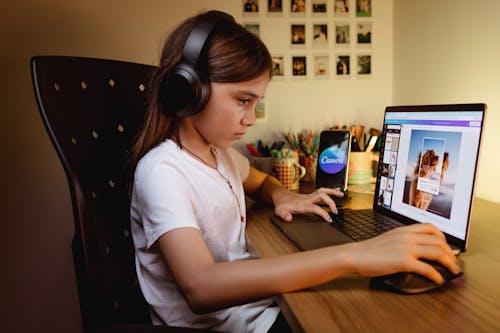 Girl with Headphones Using Canva Website