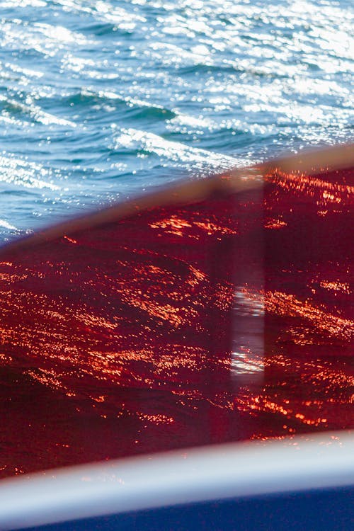 Bright Blue Sea Waves Seen Through Red Tinted Grass