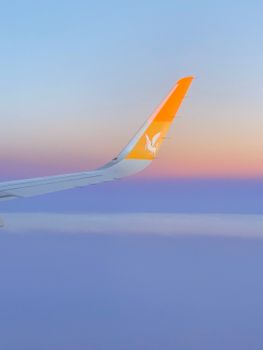Vibrant twilight view from airplane above Turkey with colorful sky and wing tip.