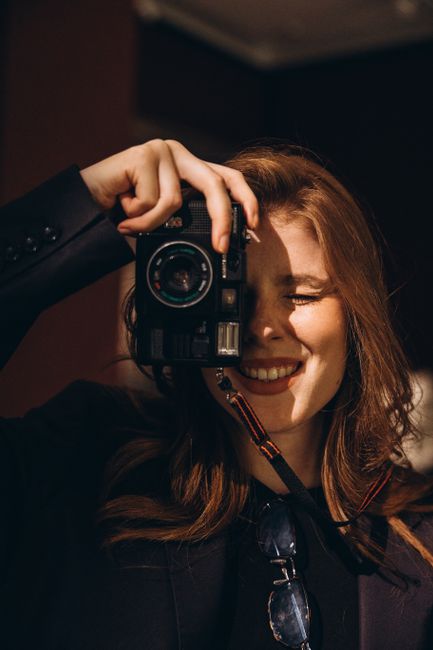 Close-up portrait of a smiling woman with a camera in Türkiye.
