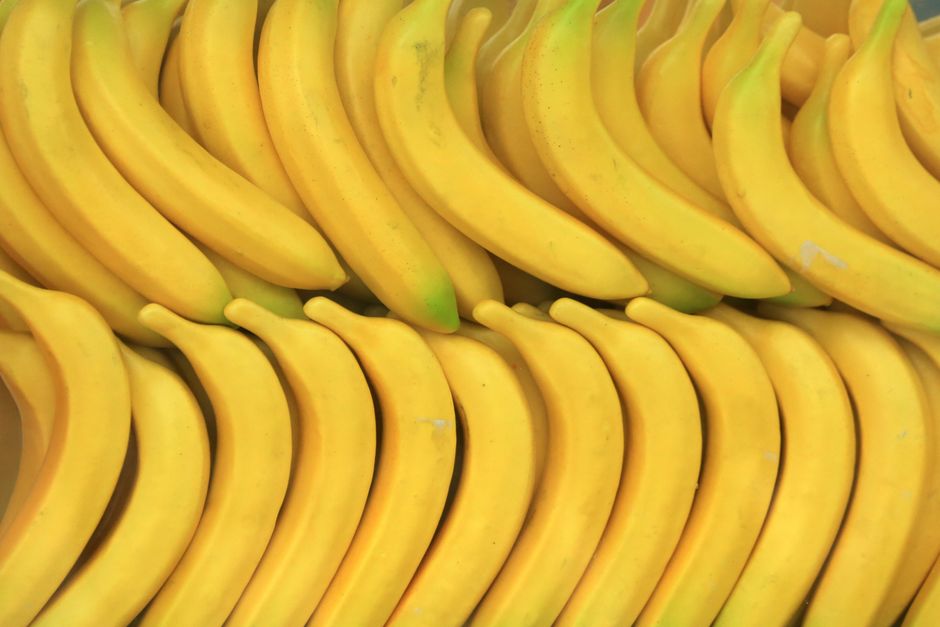 A vibrant display of ripe yellow bananas neatly arranged at a market