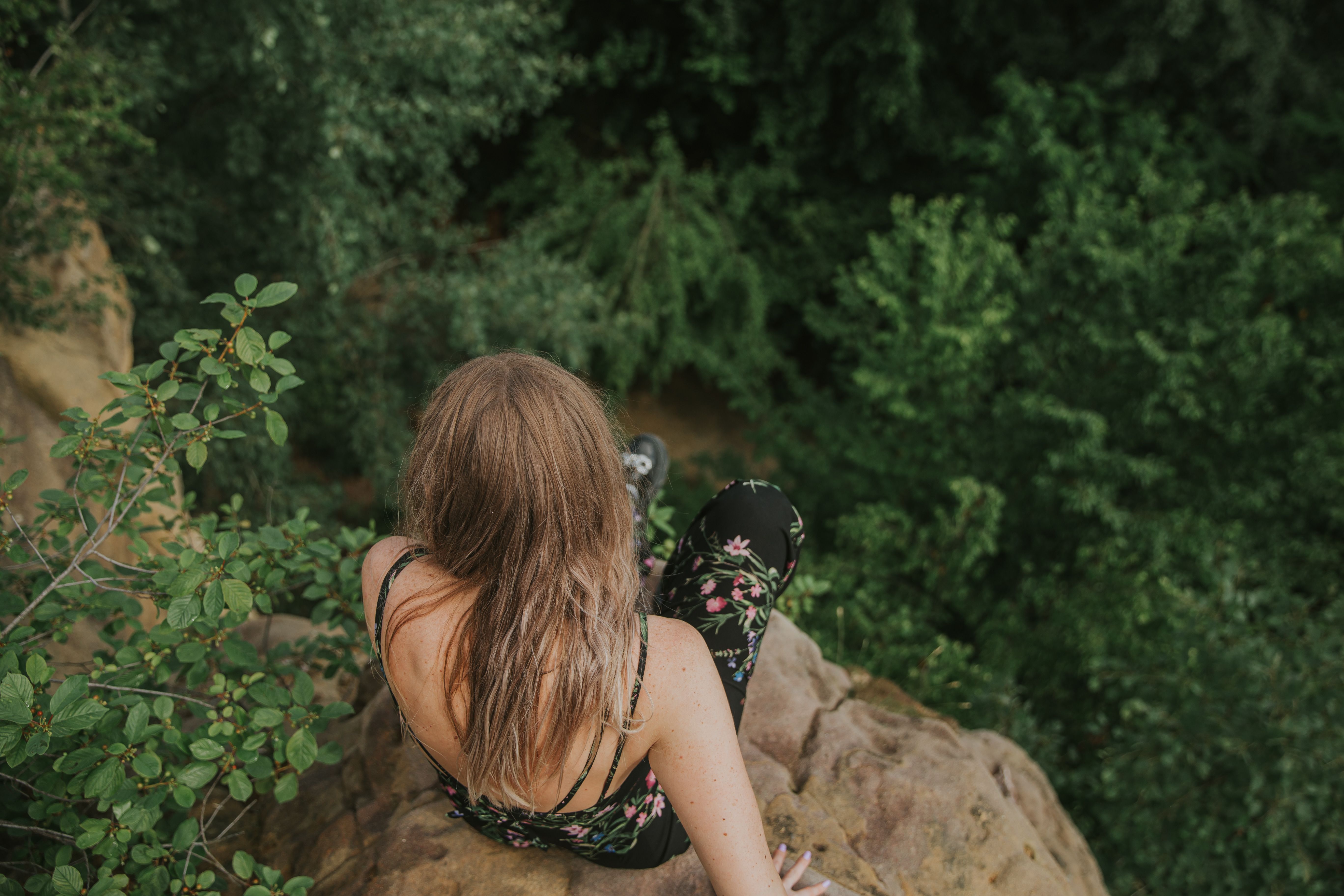 Woman Sitting on a Rock in Tropical Forest · Free Stock Photo