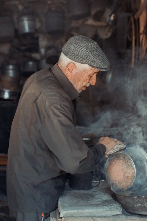 An Elderly Artisan Doing Metalwork 