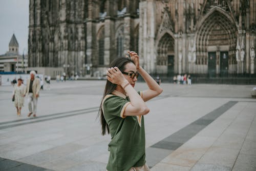 Woman in Green Polo T-Shirt Standing by Cologne Cathedral